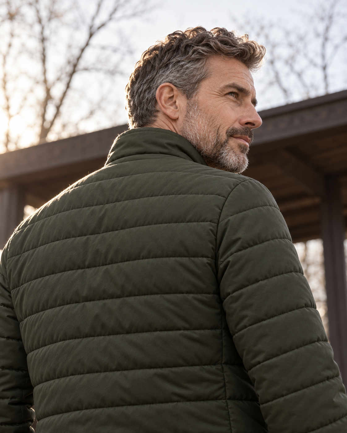 Quilted Jacket Light Urban in dark olive, back view worn by a man looking over his shoulder